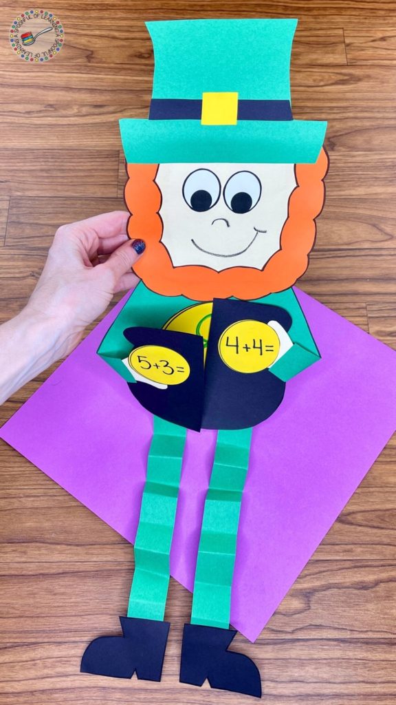 A leprechaun craft for kids where they write an addition and subtraction equation that equals the number that is on the large coin.