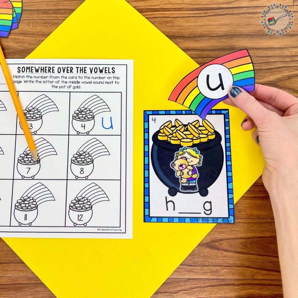 An example of one of the kindergarten centers for March where a student is putting the rainbow with the letter u to the pot of gold to show the missing short vowel sound in the word hug. 