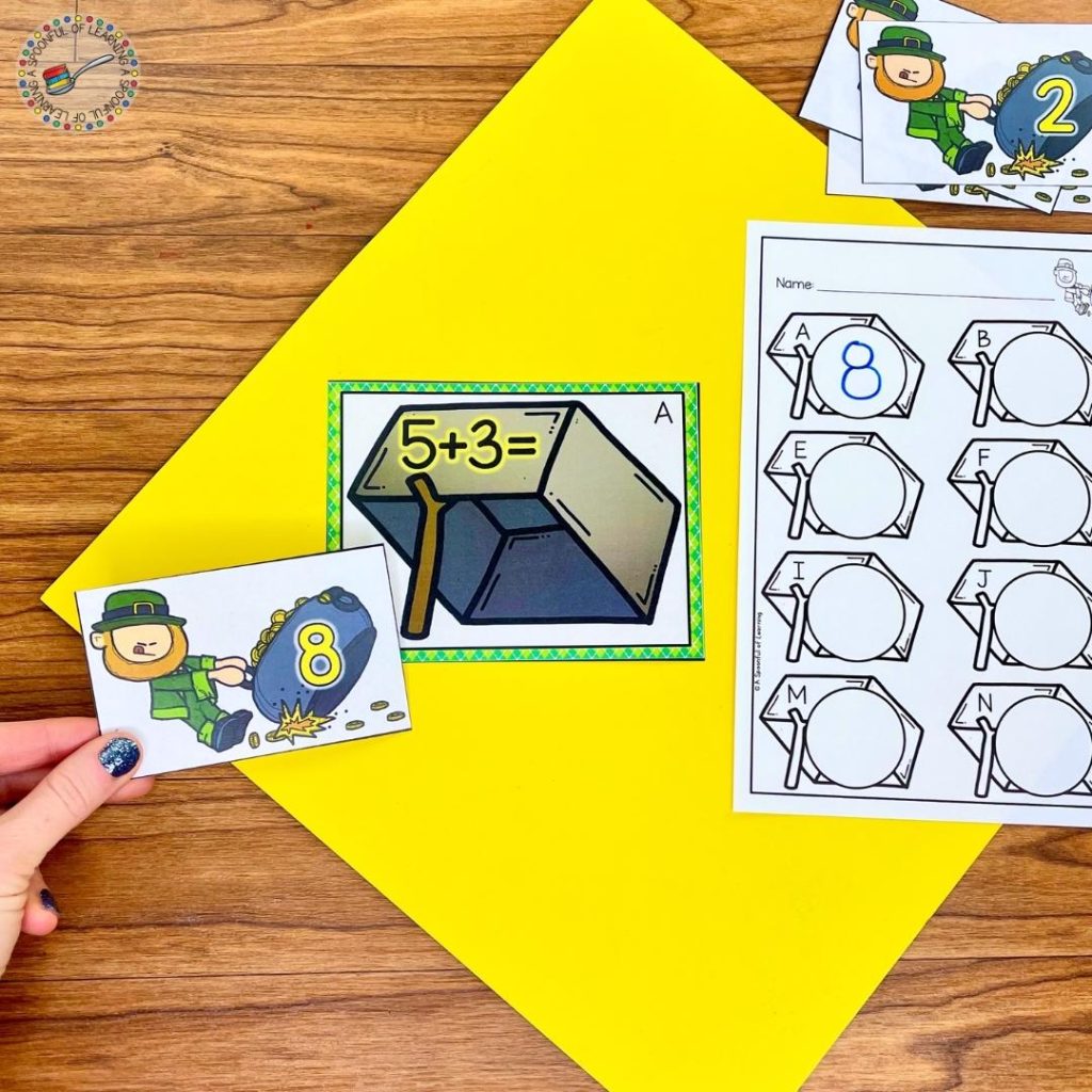 An addition activity in these March centers for kindergarten where a student placed the sum on the pot of gold to the correct equation on the leprechaun trap.