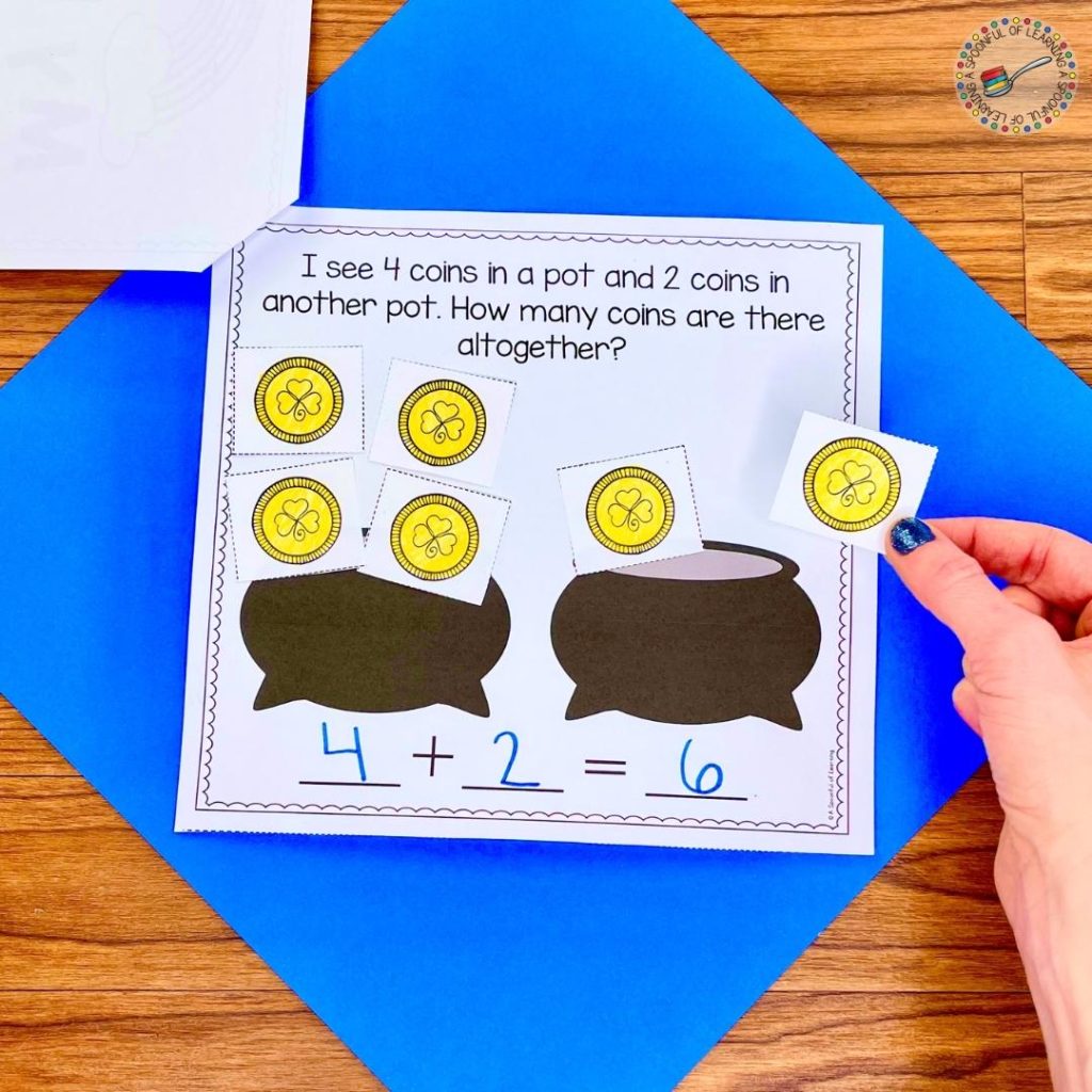 A St. Patrick's Day addition story problem where students are acting out the addition story problem using coins on pots. They write an addition equation to solve the addition story problem.