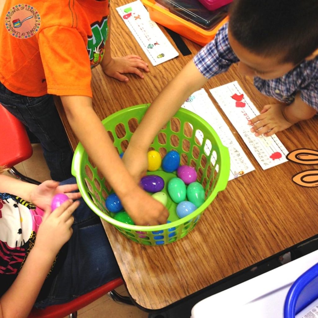 Students choosing a plastic Easter Egg from a basket.
