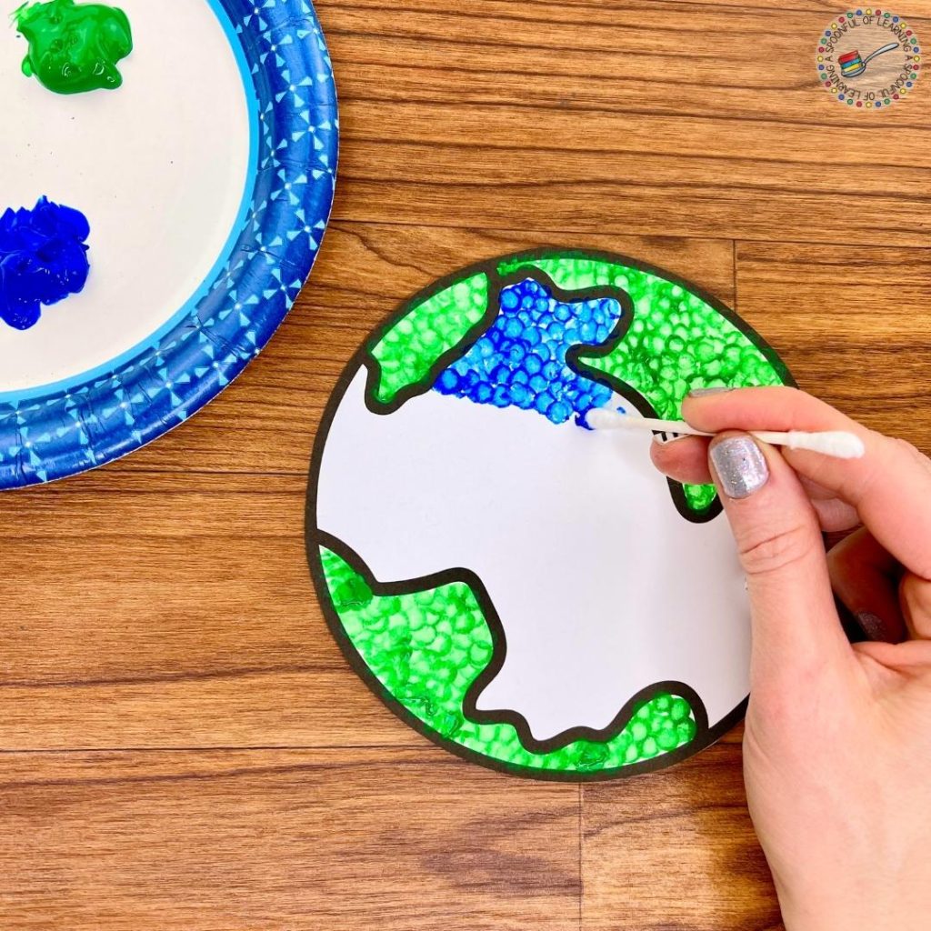 Dot painting an Earth Day craft with Q-tip
