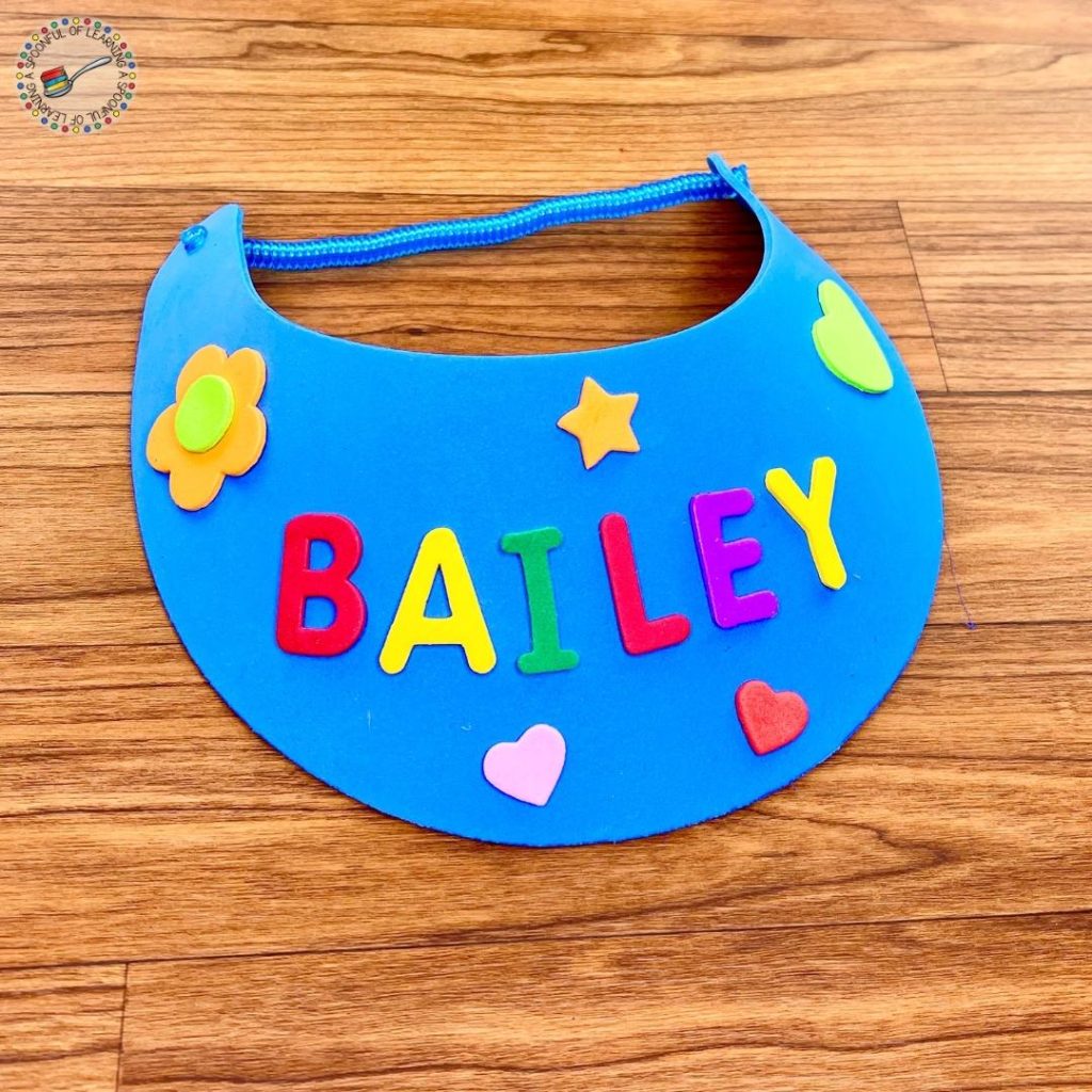 Foam visor with the name Bailey spelled in foam stickers.