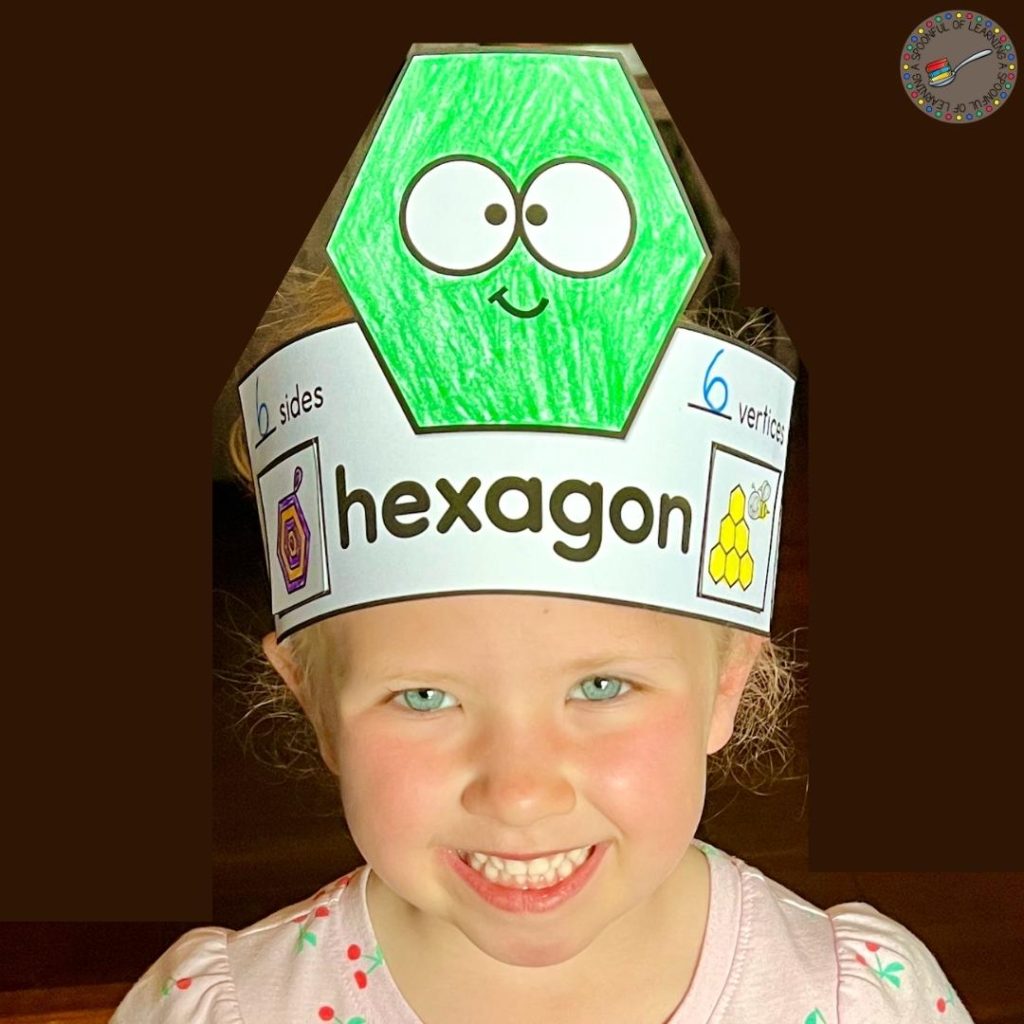 Young child wearing a 2D shape hat