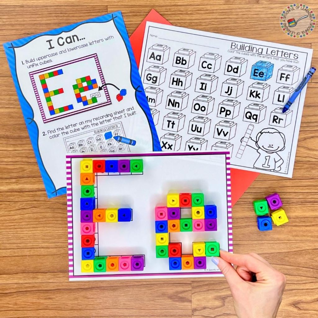 Building the letter Ee on a mat with colorful snap cubes
