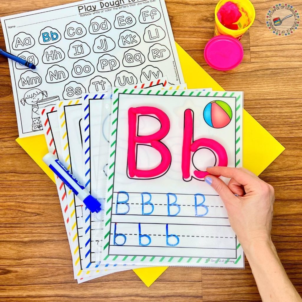 The letter B is being built with play dough on a play dough and letter writing mat.