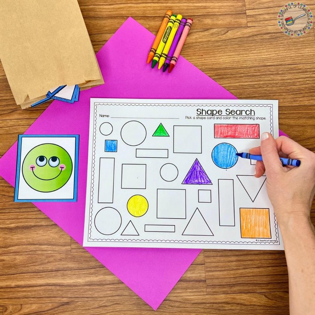 Coloring in a shape search worksheet after choosing a card from a paper bag