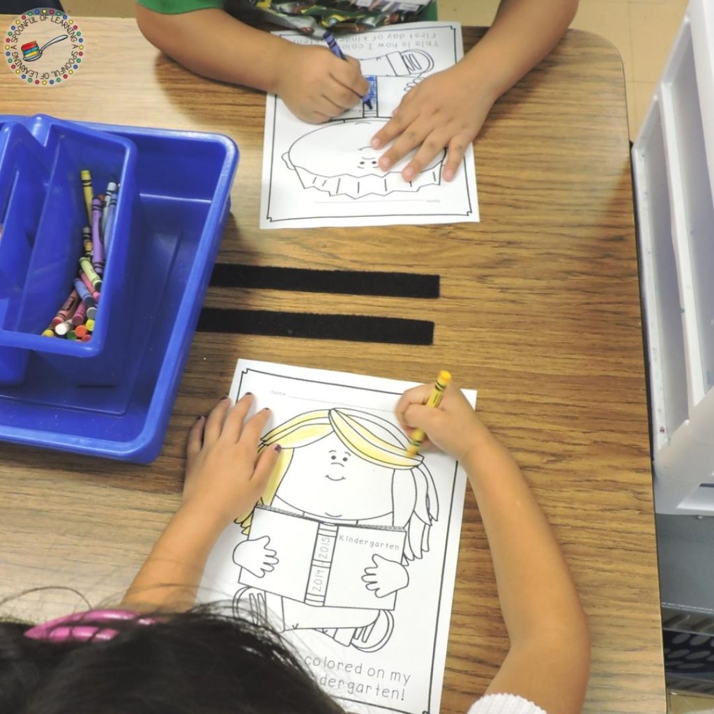 Two students coloring first day of kindergarten pages