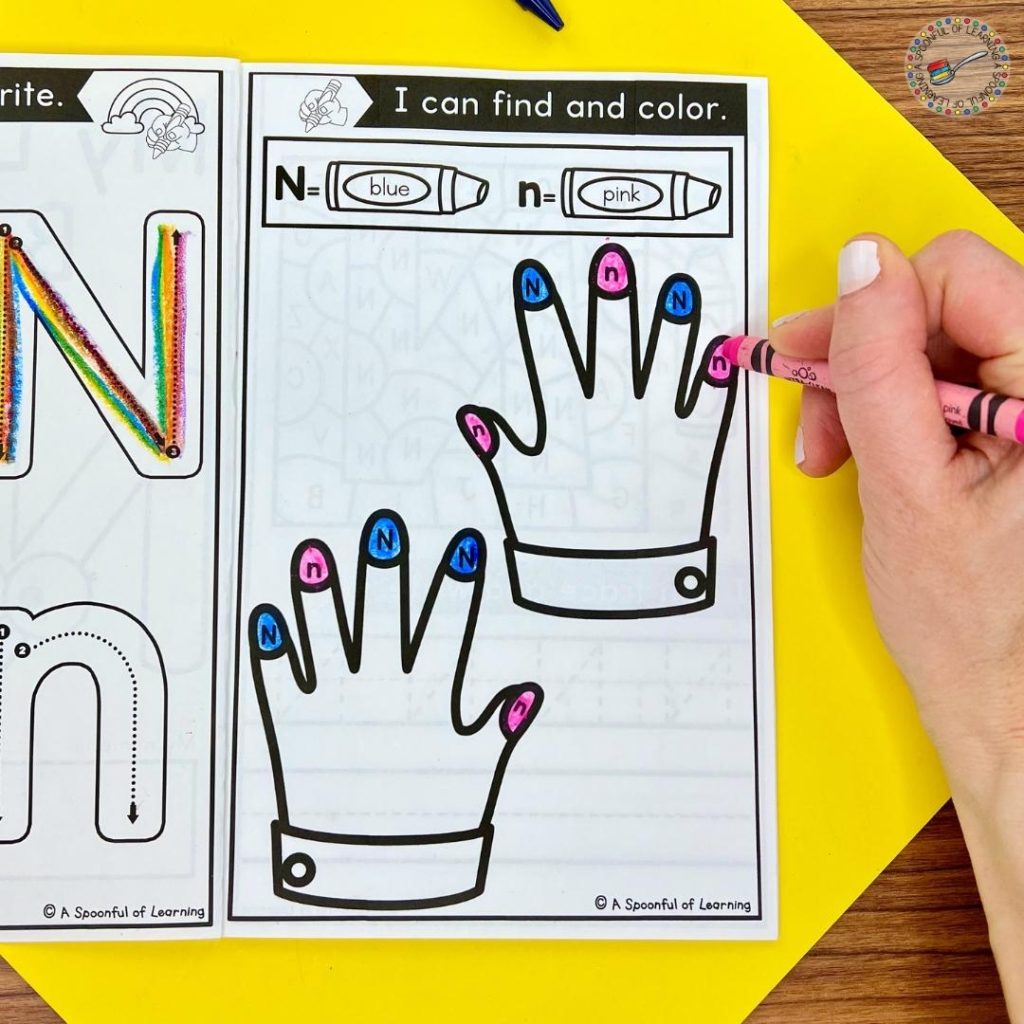 Coloring the fingernails on hands in an alphabet book