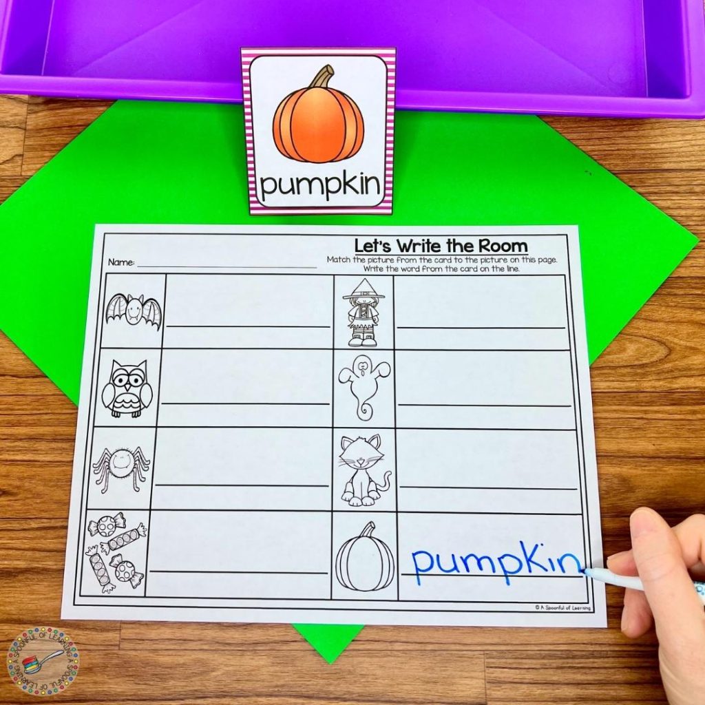 Copying the word pumpkin onto a recording sheet