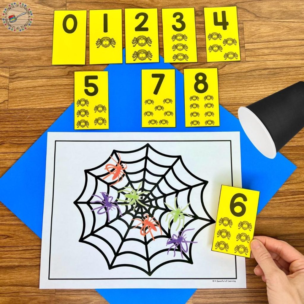 A spider themed counting game with plastic spiders