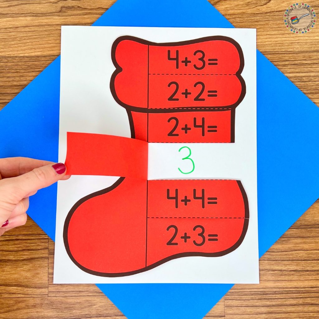 A lift-the-flap addition activity shaped like a stocking