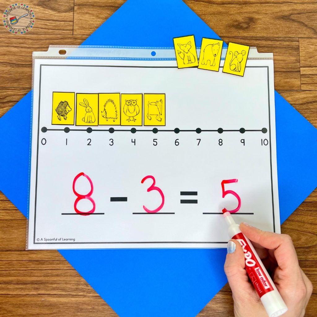 A subtraction mat with a number line and animal cards