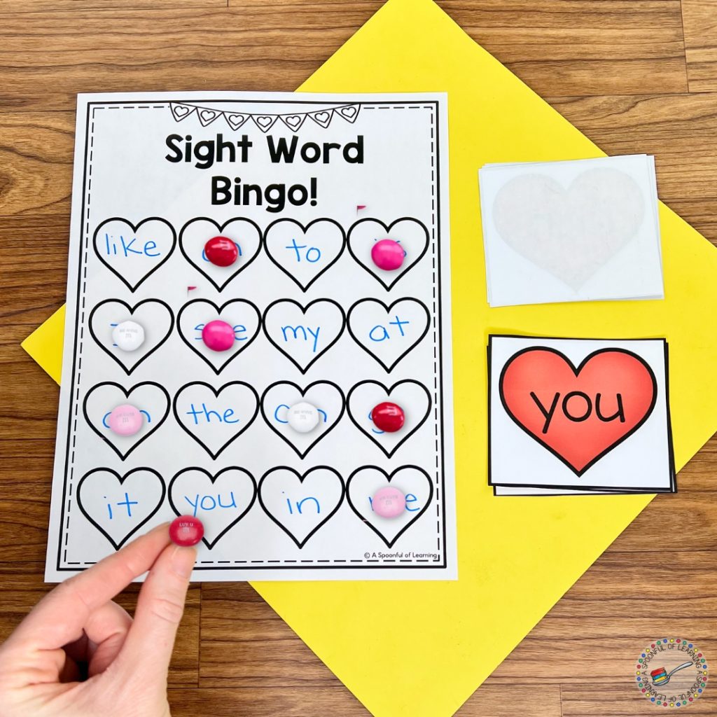 Sight word bingo sheet being marked with candy