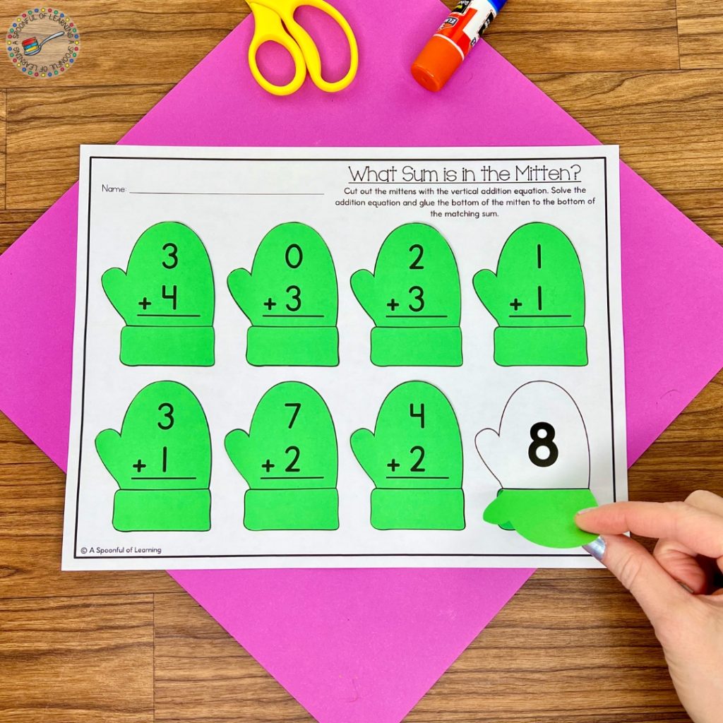 A vertical addition worksheet with green mitten flaps