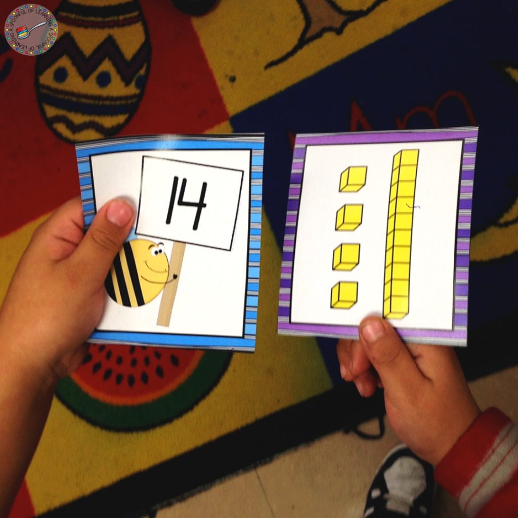 Students matching base ten card to a teen number card