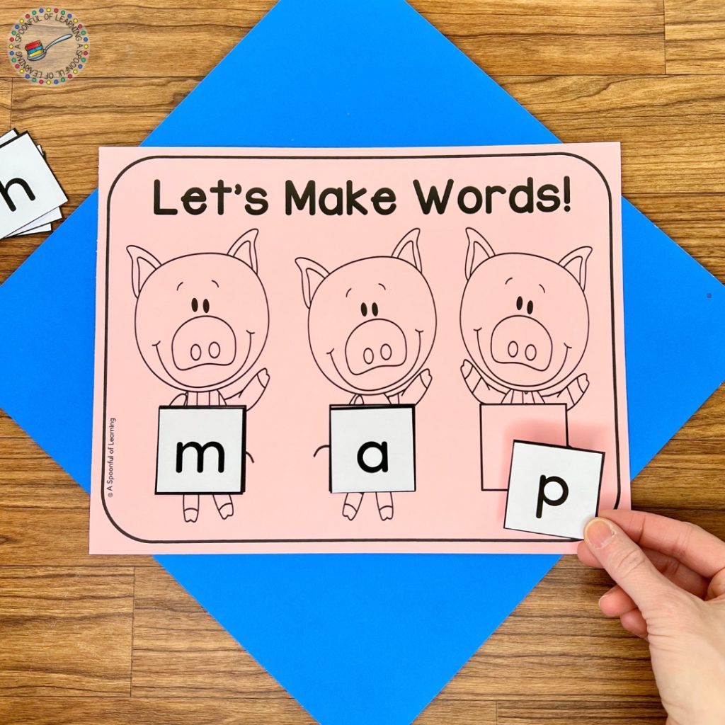 A CVC word building mat with images of the three little pigs
