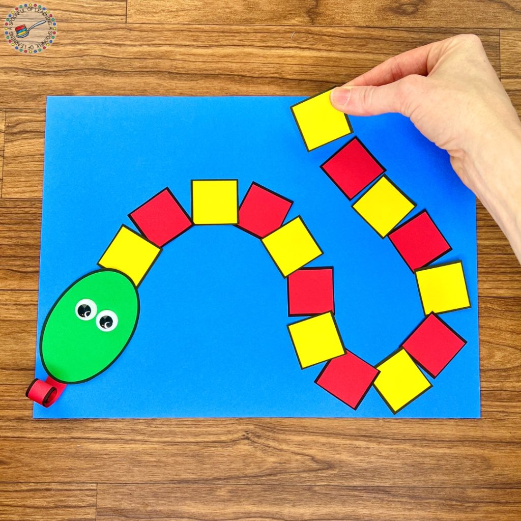 A snake craft made from colored squares arranged in a pattern