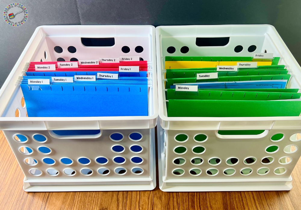 Two white crates with green, blue, and red file folders. Activities have been added to some folders