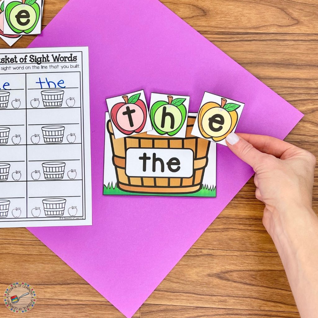 Arranging apple letter cards to spell the word "the"