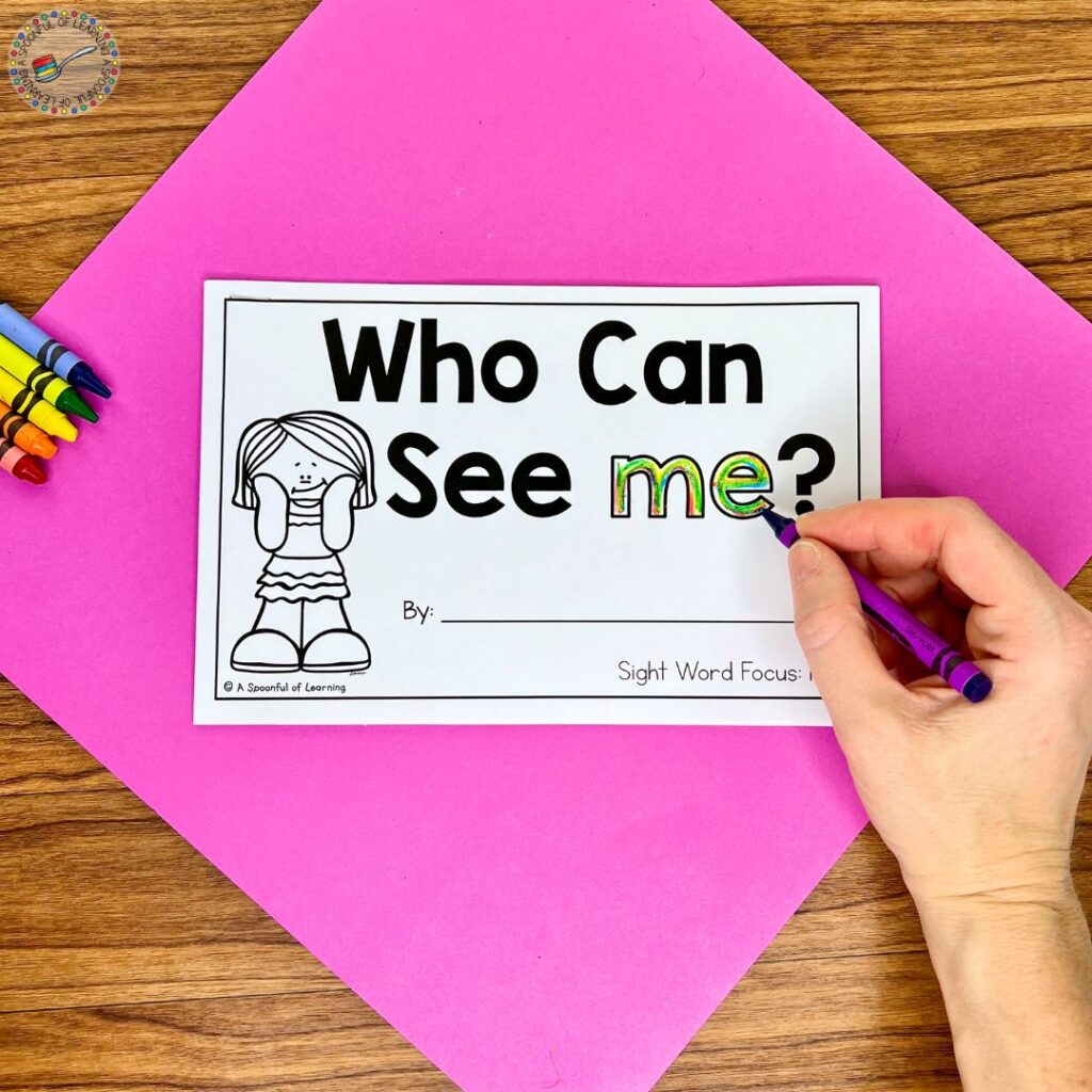 Rainbow writing the word "me" on the cover of a sight word reader titled "Who Can See Me?"