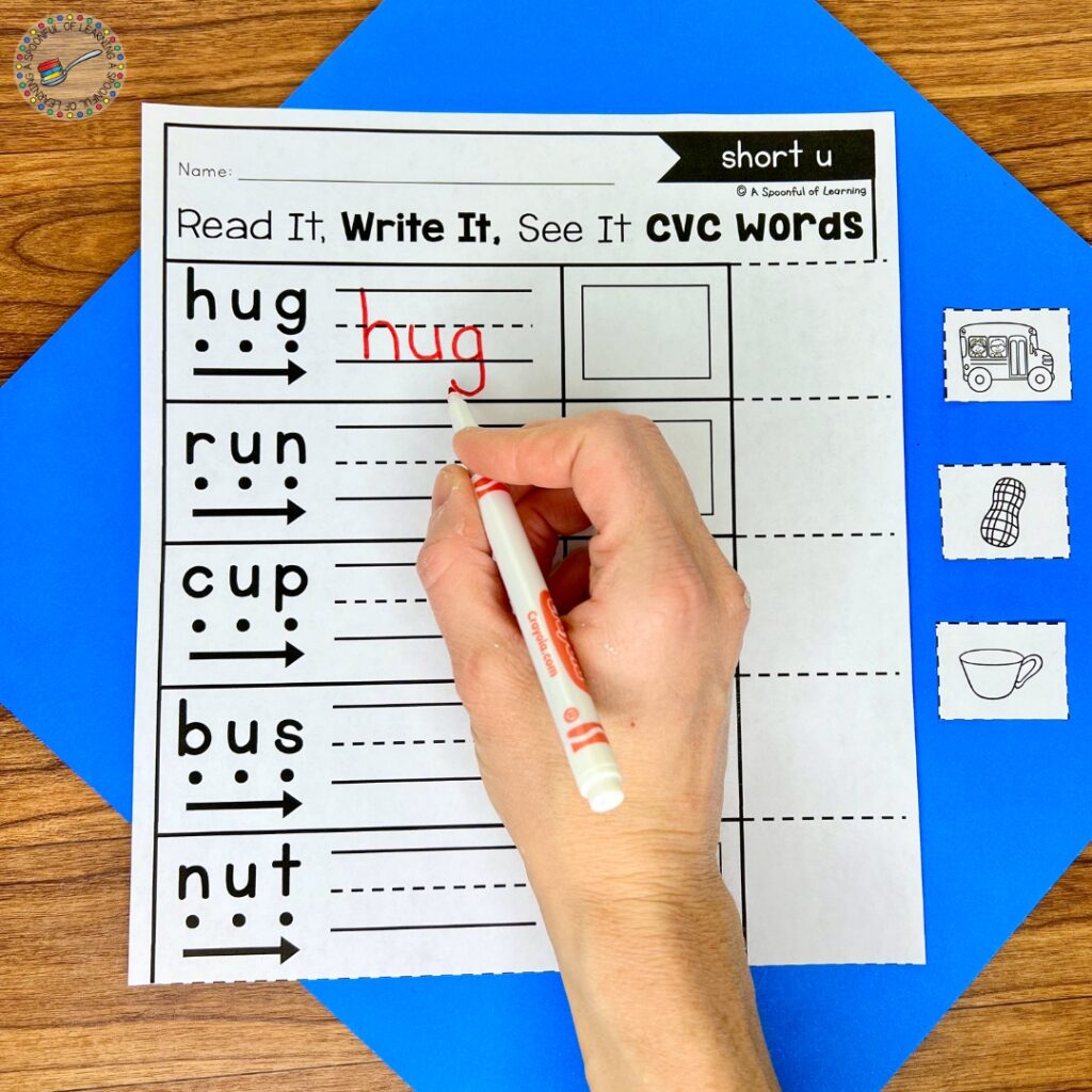 Writing the word "hug" on a worksheet