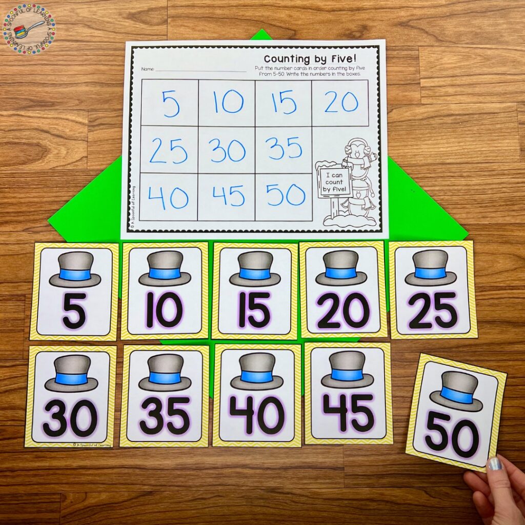 Putting number flashcards in order, counting by 5