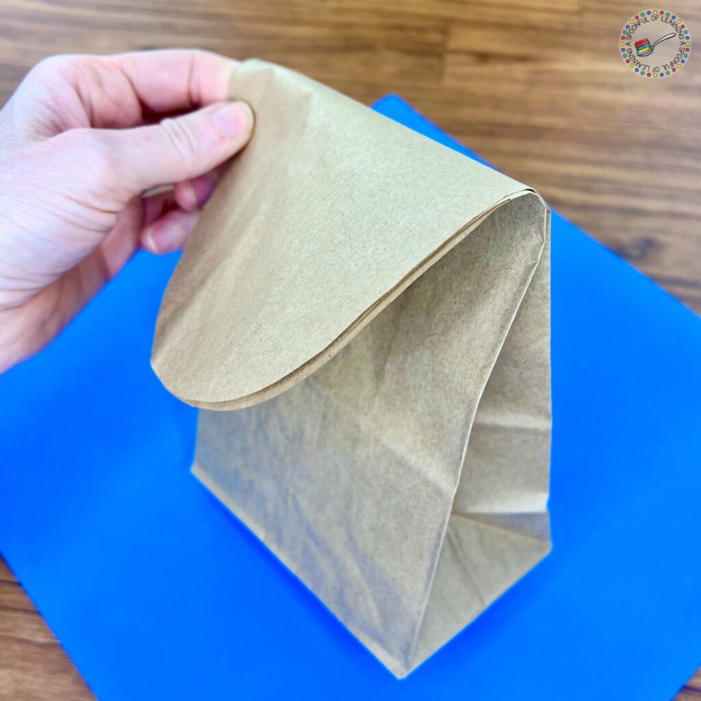 Folding down the top of a paper bag