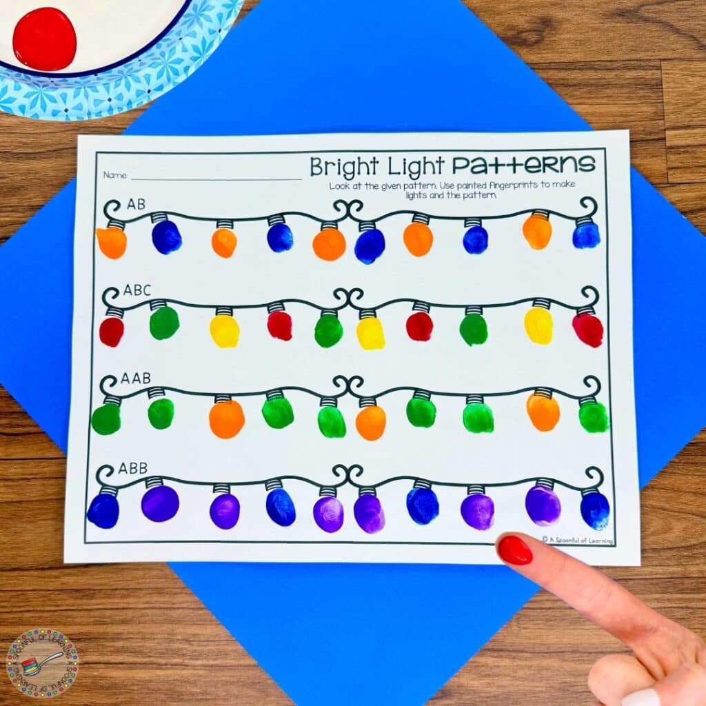 Finger painting Christmas lights on a worksheet