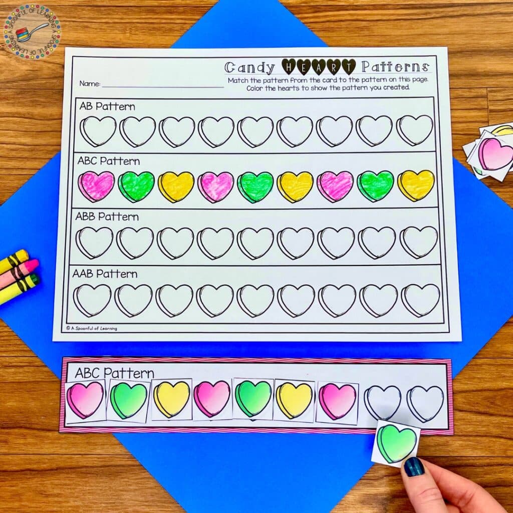 Making patterns by coloring hearts on a worksheet