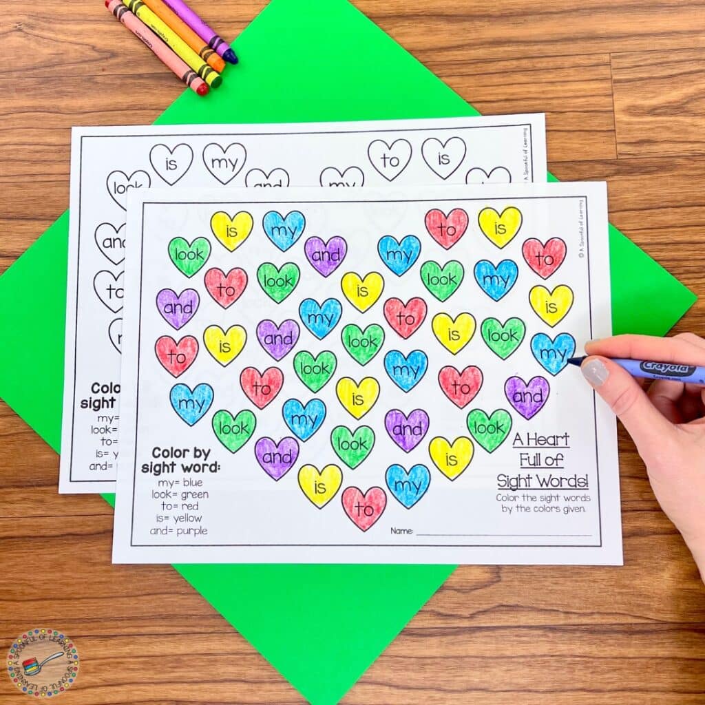 Coloring a variety of hearts with sight words written on them